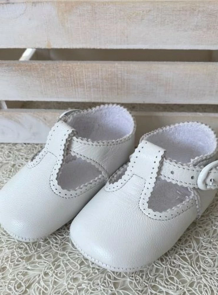 Baby shoe in light white or navy patent leather.
