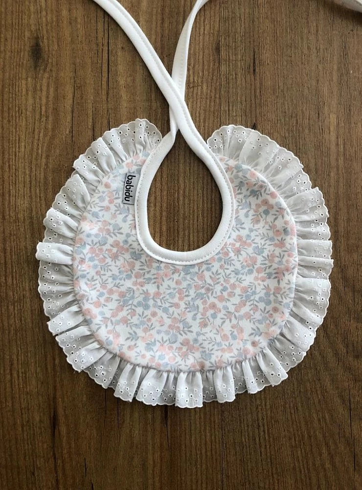 Bib with embroidered strip.Liberty Collection