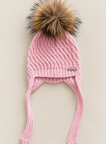 Children's cable-knit hat with earflaps and a natural fur pom-pom.