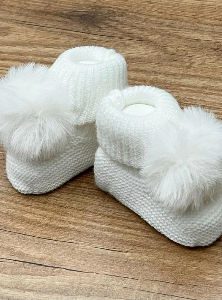 Chubby knit bootees with a fur pompom. Adriatic Collection