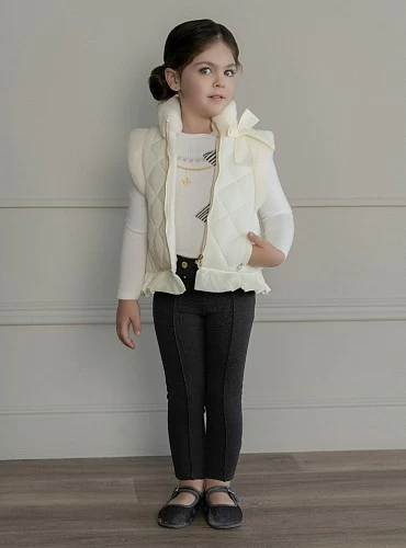 Cream-colored quilted vest for girls