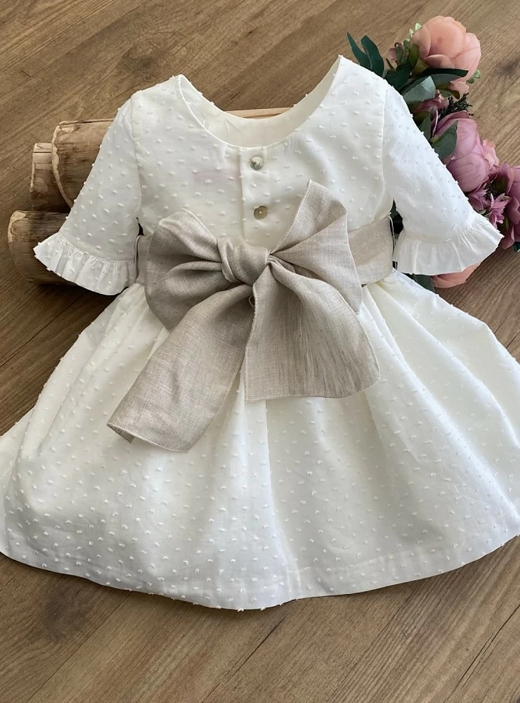 Ecru plumeti flower dress with sand linen bow.