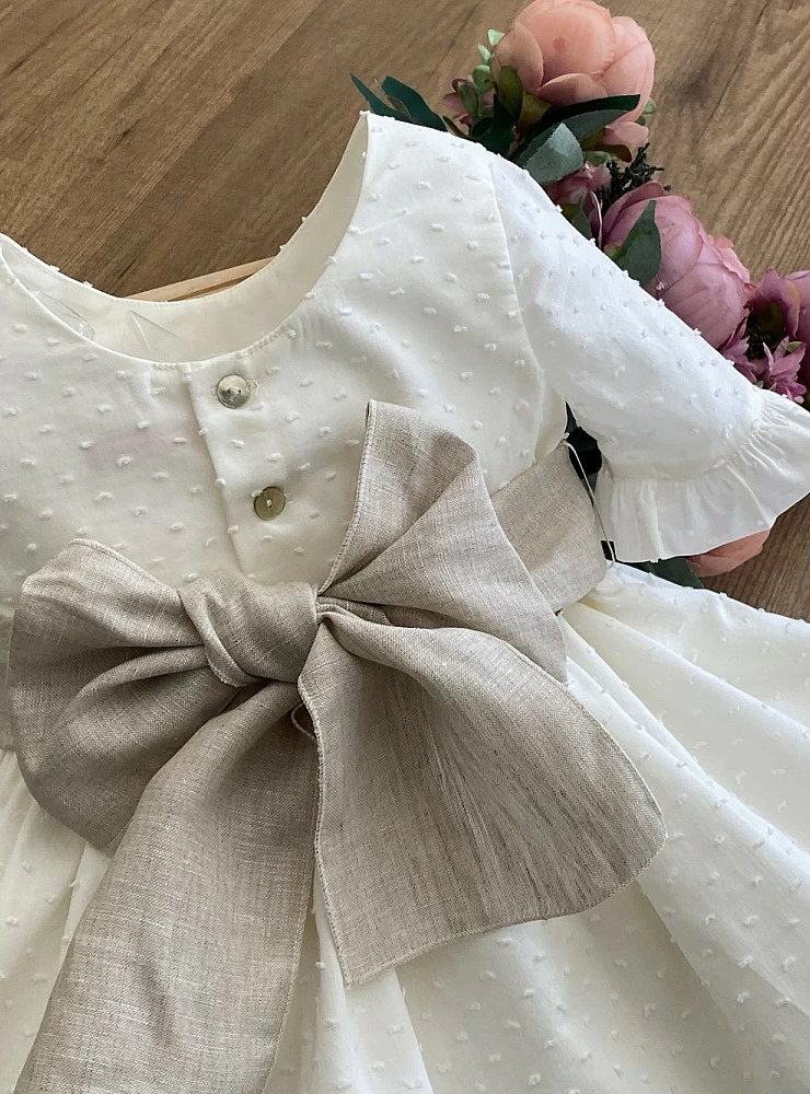 Ecru plumeti flower dress with sand linen bow.