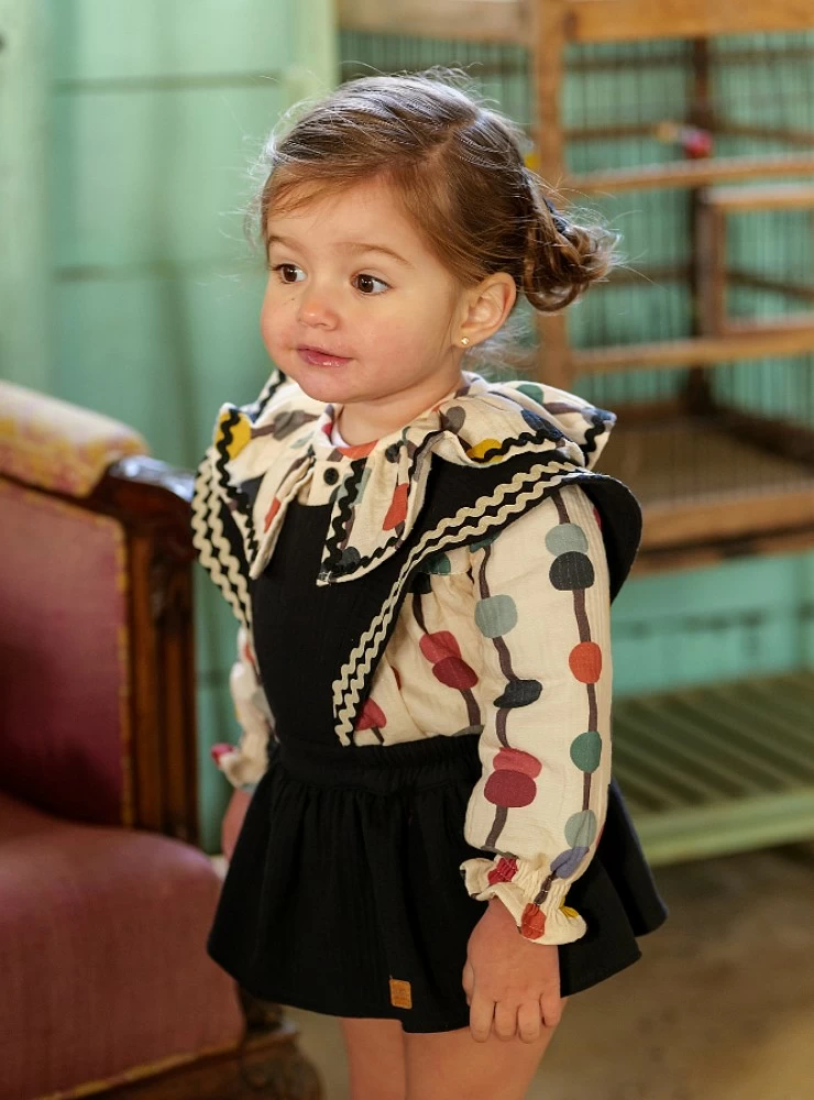 Girl's overalls and blouse set from the Luna Negra collection by José Varón