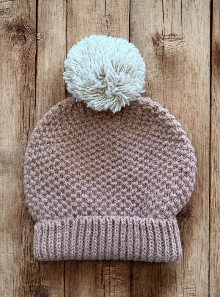 Knitted hat with pompom. Mistral Collection