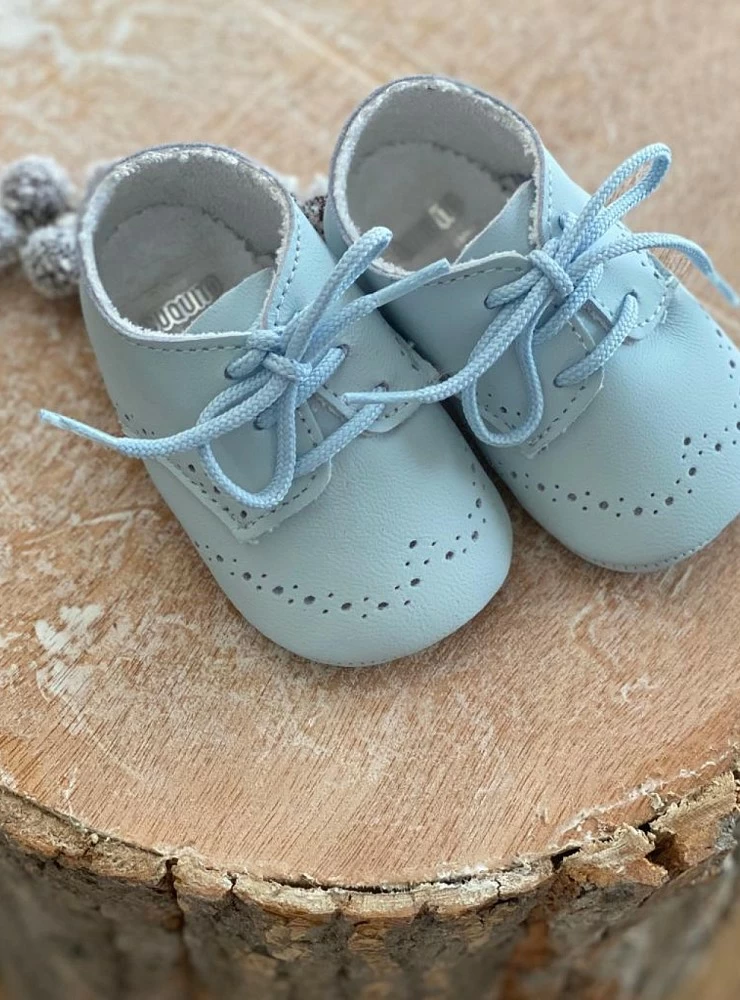 Little boy's shoe in white or light blue. Very cute