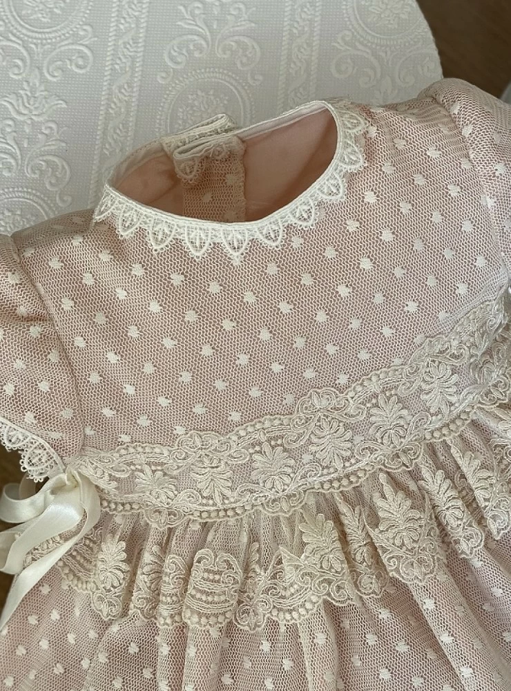 Pink and beige dress and bonnet set.