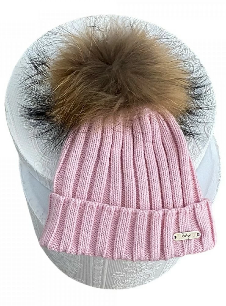 Ribbed hat in various colors. She wears a hair pompom.