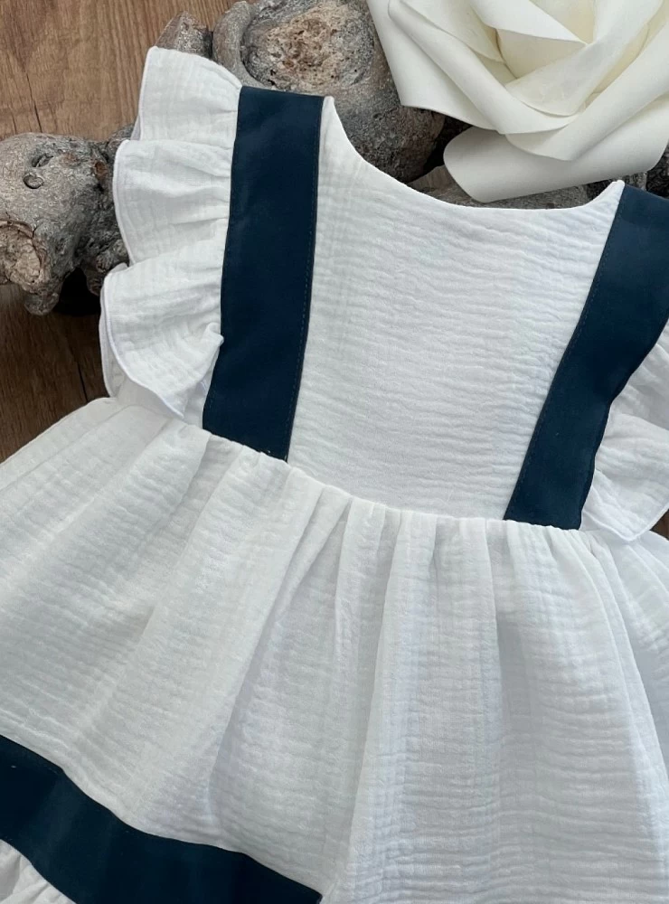 White and navy arras or ceremony dress by Eve Children