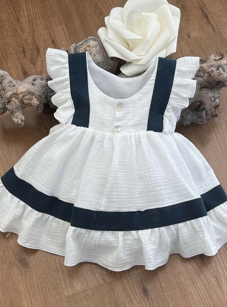 White and navy arras or ceremony dress by Eve Children